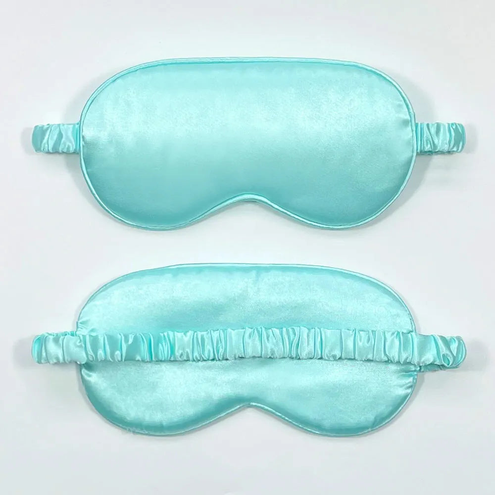 Double-sided silk-like sleep mask in rayon satin, shown in multiple colour options on a white background.