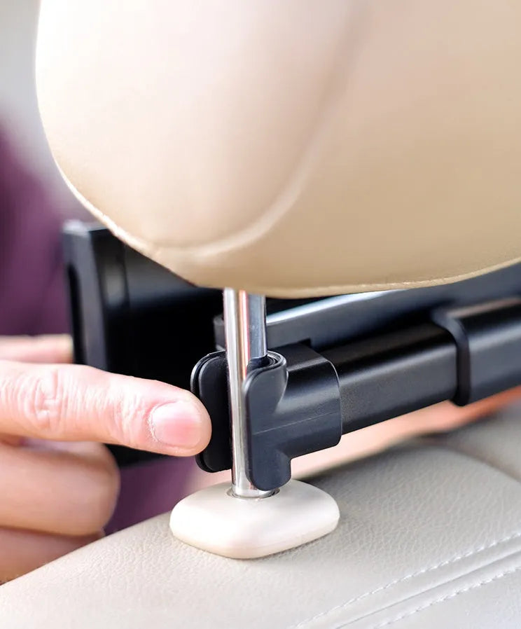 Black plastic car phone holder attached to a vehicle rear seat base holding a tablet