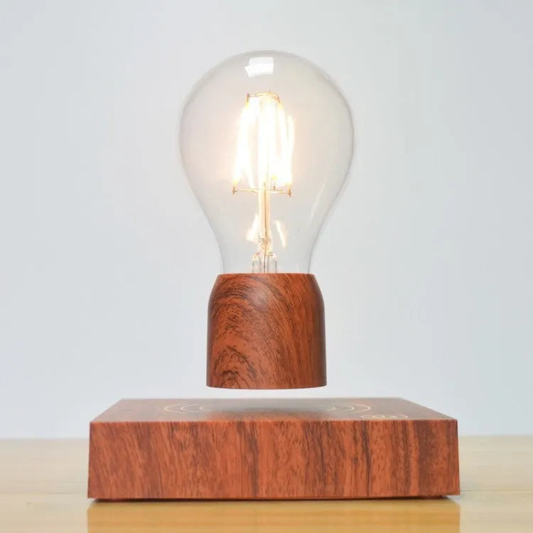 Magnetic levitation floating light bulb with imitation wood base on a table.