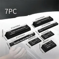 Seven black frosted building blocks with metal construction arranged as a set