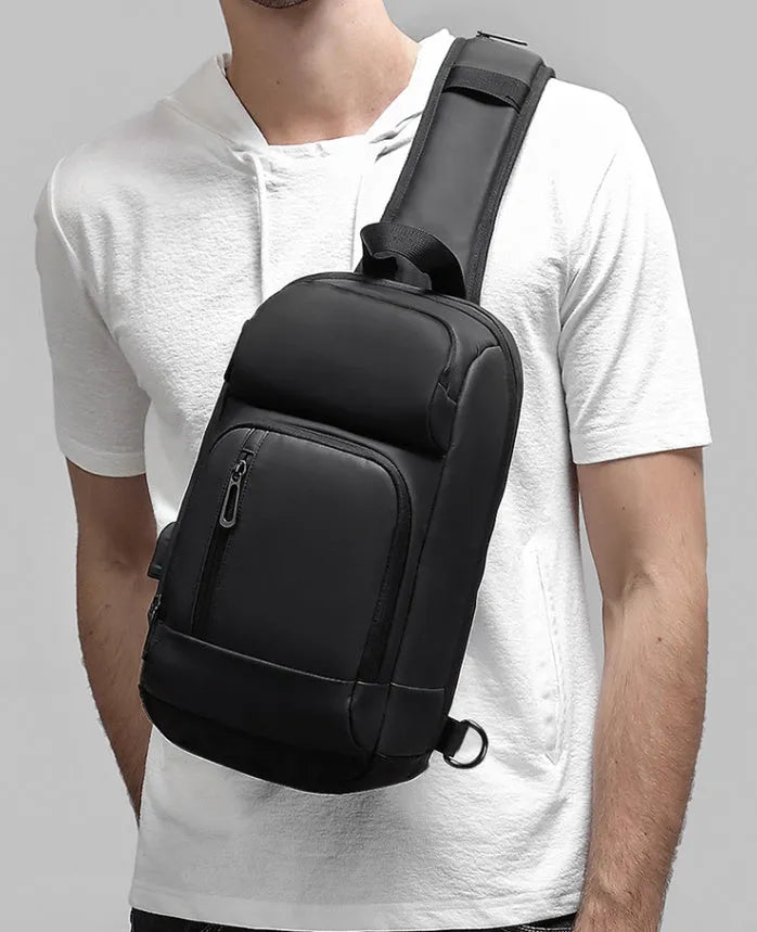 Black outdoor shoulder bag with air cushion strap showing internal laptop and organiser pockets