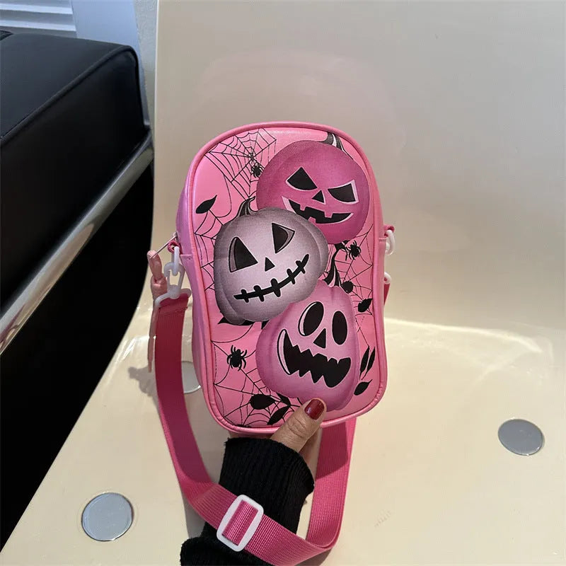 Black mini crossbody bag with Halloween cartoon print of pumpkins, ghosts, and bats.