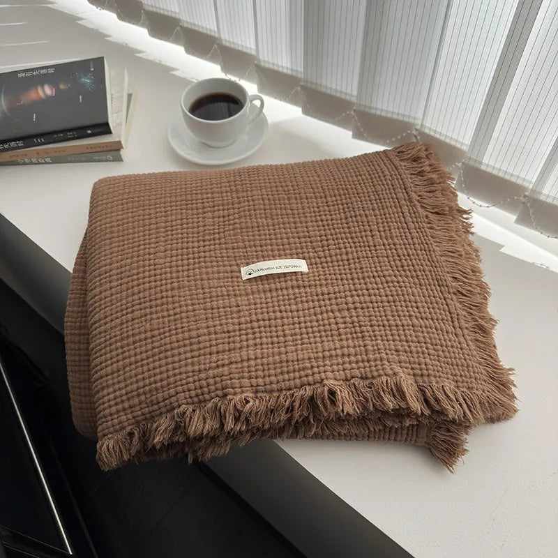 Four-layer gauze cotton blanket with tassel trim in a choice of ten colours and two sizes.