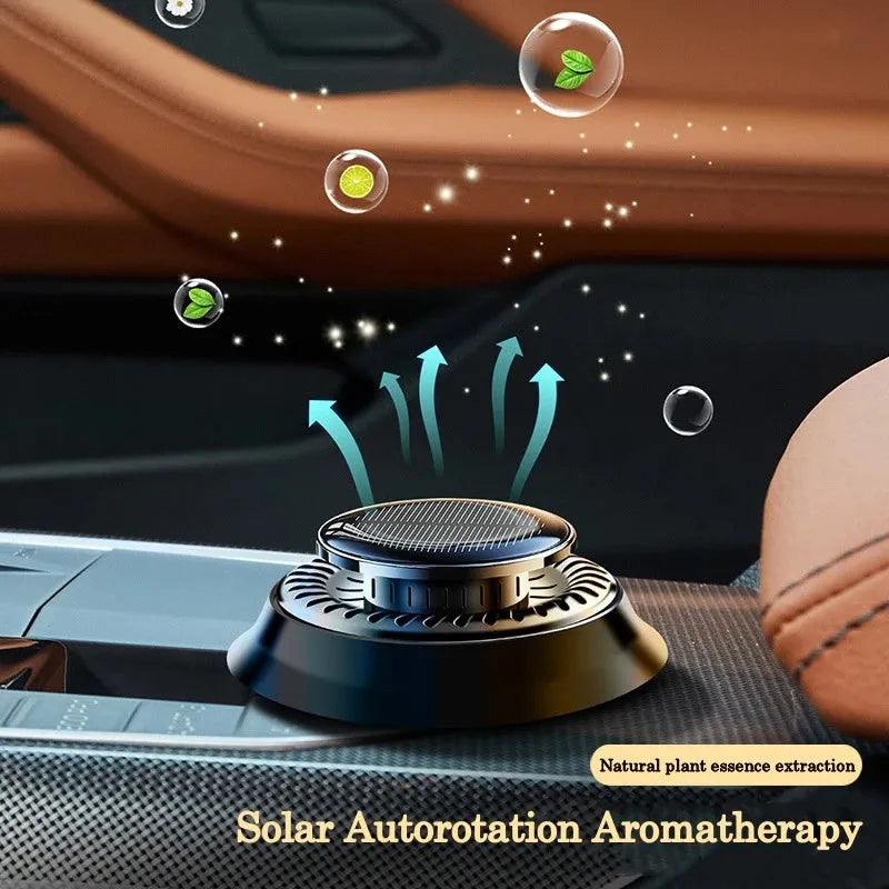 Solar-powered kinetic double-ring car air freshener diffuser in black plastic.