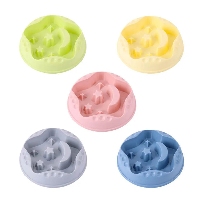 Blue slow feeder dog bowl with moon and star wing design and internal maze pattern.
