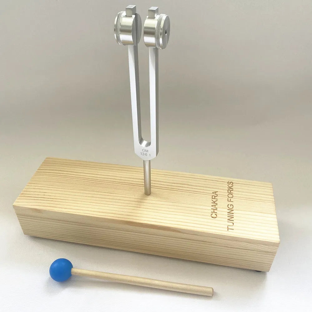 Aluminium alloy 432Hz tuning fork with connected speaker on kraft paper box