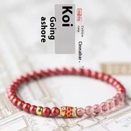 Purple and pink cinnabar and strawberry quartz beaded bracelet with peach blossom and koi designs.