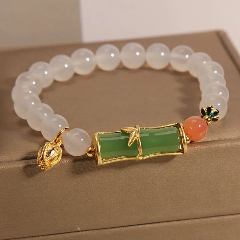 White agate and jade bamboo beaded bracelet with jasper accents on a neutral background.