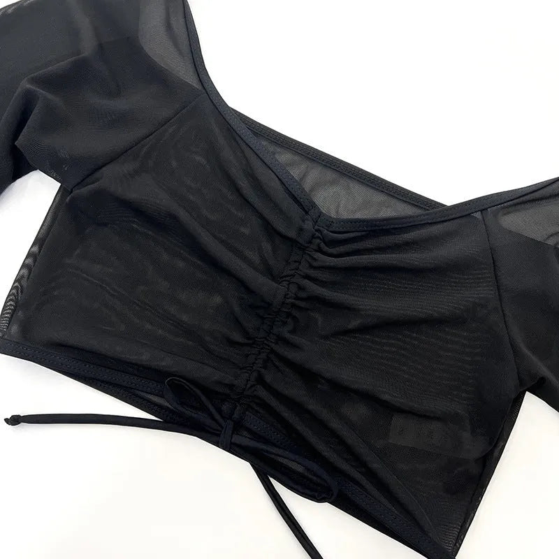 Black long sleeve women's bikini top and briefs, four-piece swimwear set.