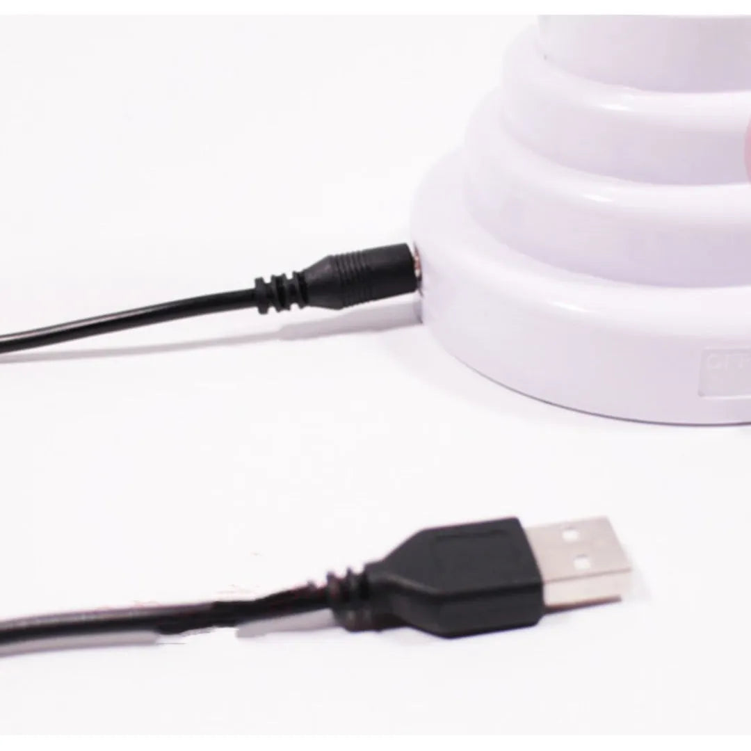 Minimalist bamboo-shaped desktop lamp with white tube emitting green light, USB powered