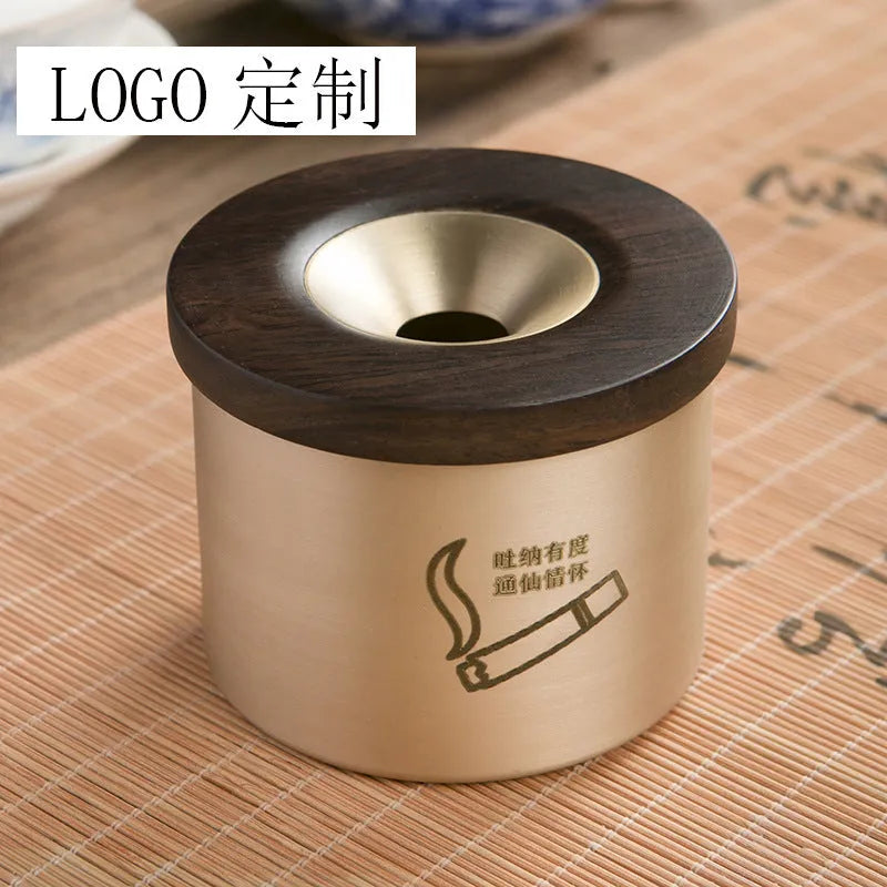 Retro brass ashtray with wooden lid showing centre hole design for ash collection