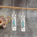 Silver geometric earrings with a long strip design and a blue turquoise inlay