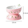 Ceramic raised cat bowl in orange pattern, showing tilted wide-rim design on elevated stand.