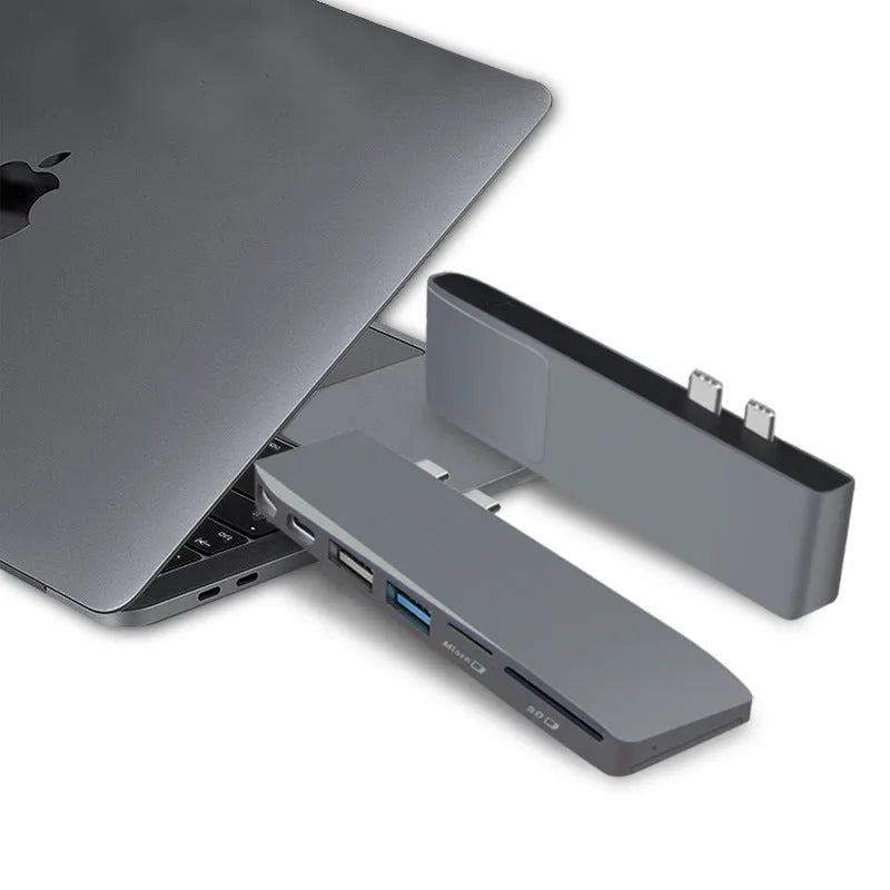 Silver 8-in-1 USB-C hub for MacBook Pro with dual connectors, showing USB, card reader, and charging ports