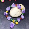 Purple natural shaped amethyst bead bracelet for women with a fu character charm.