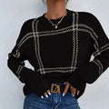 Women's loose-fit plaid sweater with apricot, black, beige, red, and green colour-block stripes.