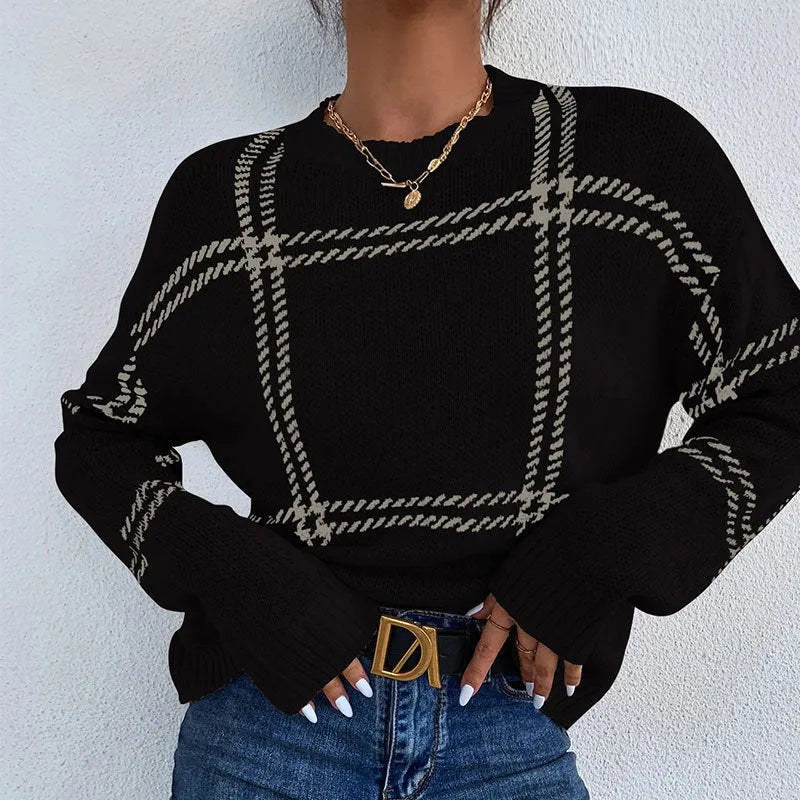 Women's loose-fit plaid sweater with apricot, black, beige, red, and green colour-block stripes.