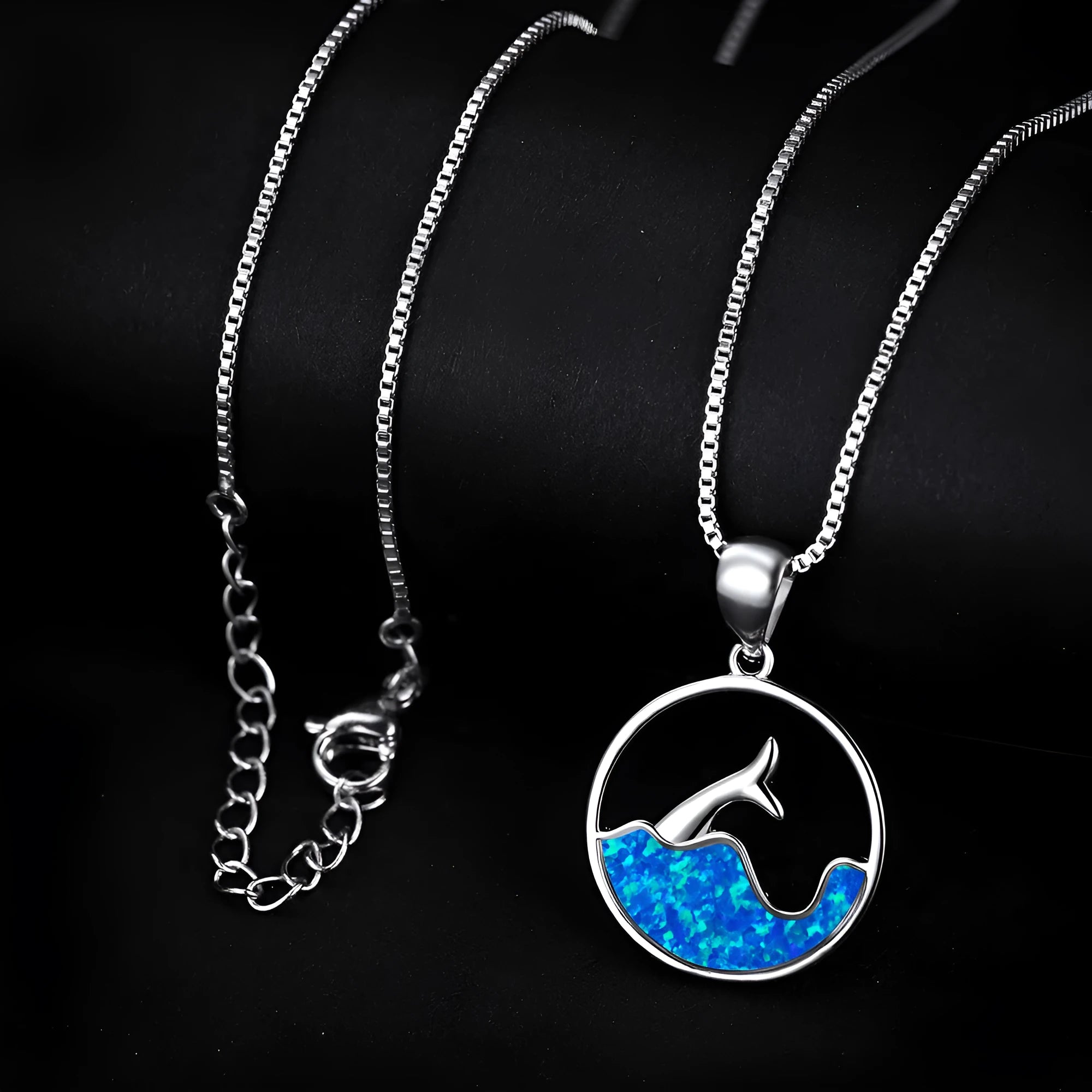 White gold electroplated copper necklace with a geometric sea fishtail pendant in a blue opal tone.
