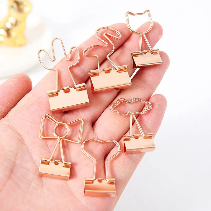 Gold metal paper clip with decorative shape options including bow, cactus, cat, flamingo, love, and clouds.