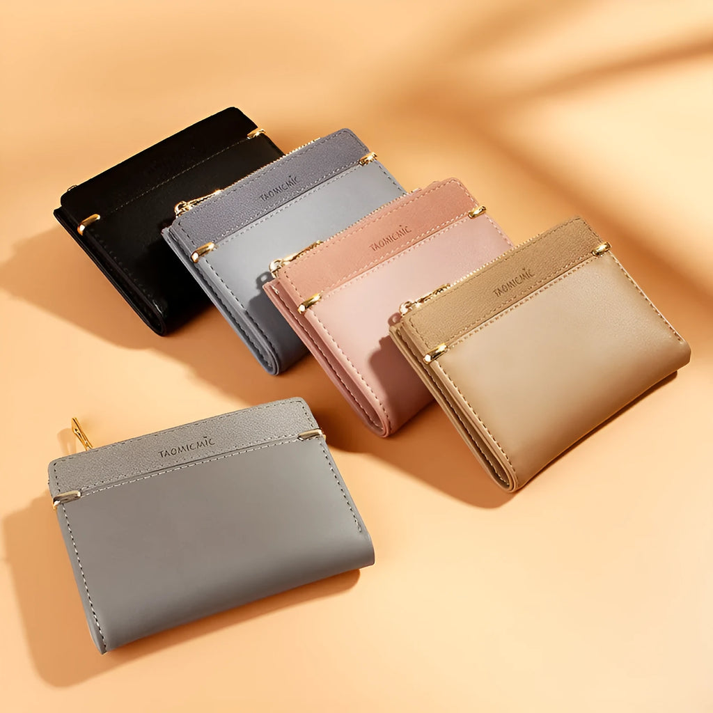 Black ladies short zipper wallet open to show multiple card slots, bill compartment, and change slot.
