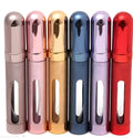 Slender aluminium travel perfume bottle with glass liner in a choice of six colours, shown next to a ruler showing 115mm length.