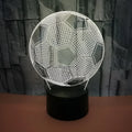 3D football-shaped night light showing multicolour illumination on acrylic surface