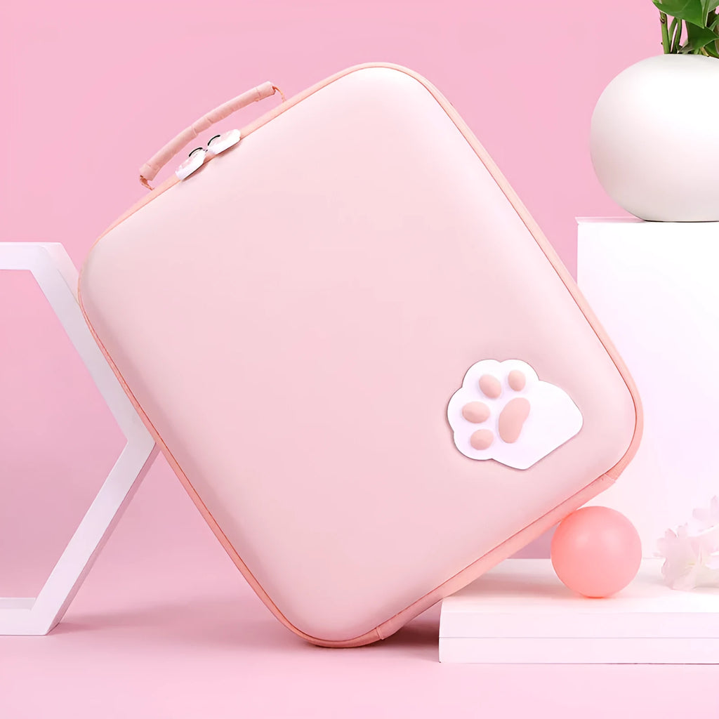 Nintendo Switch storage carry case in pink, shown with game card slots and a diagonal shoulder strap.