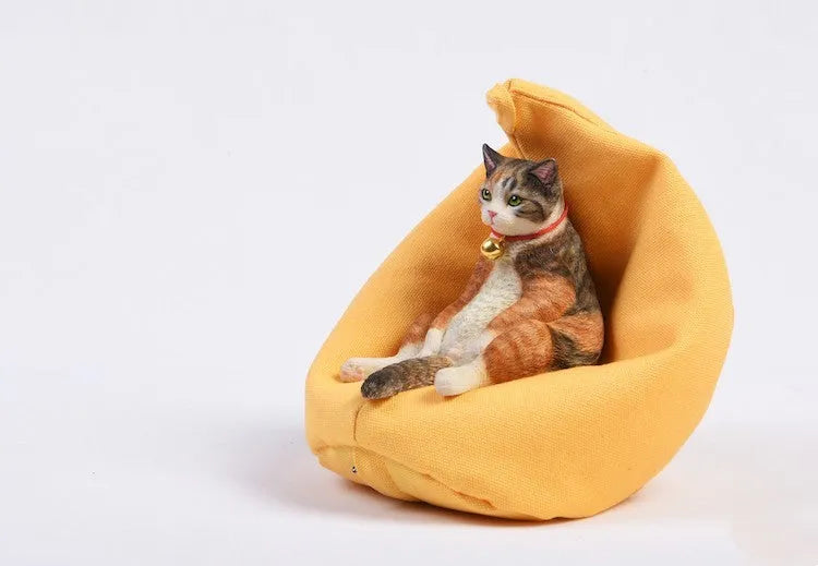 Small resin cat ornament sitting on fabric sofa for car dashboard decoration