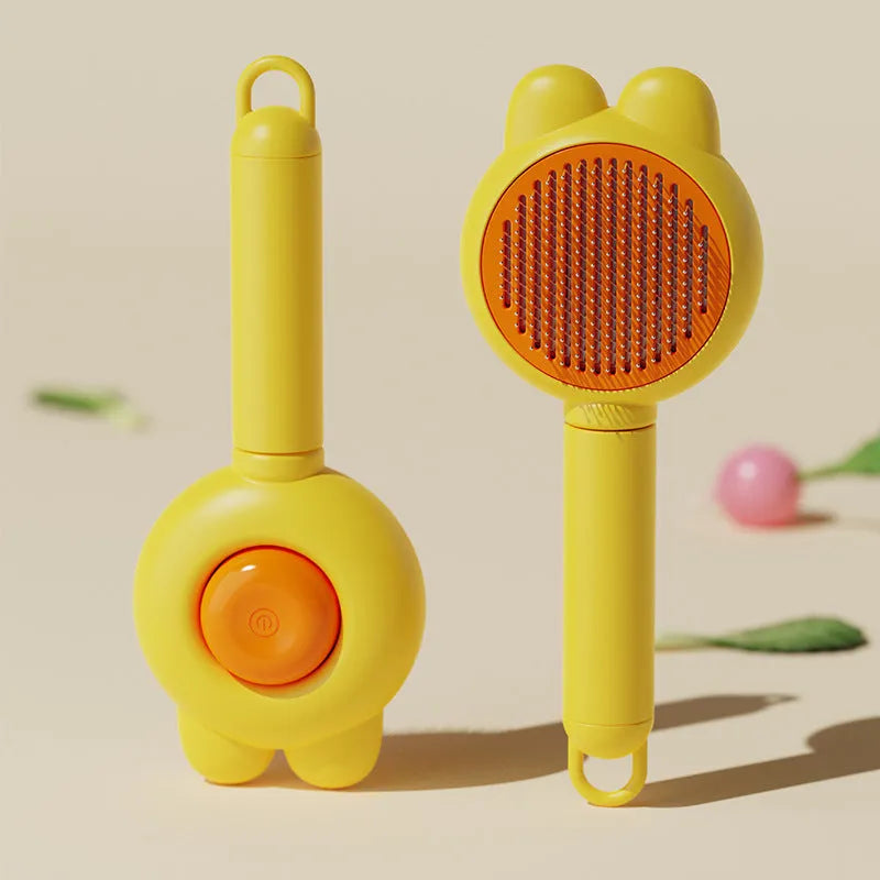Green pet grooming brush with a self-cleaning button and a stainless steel comb.