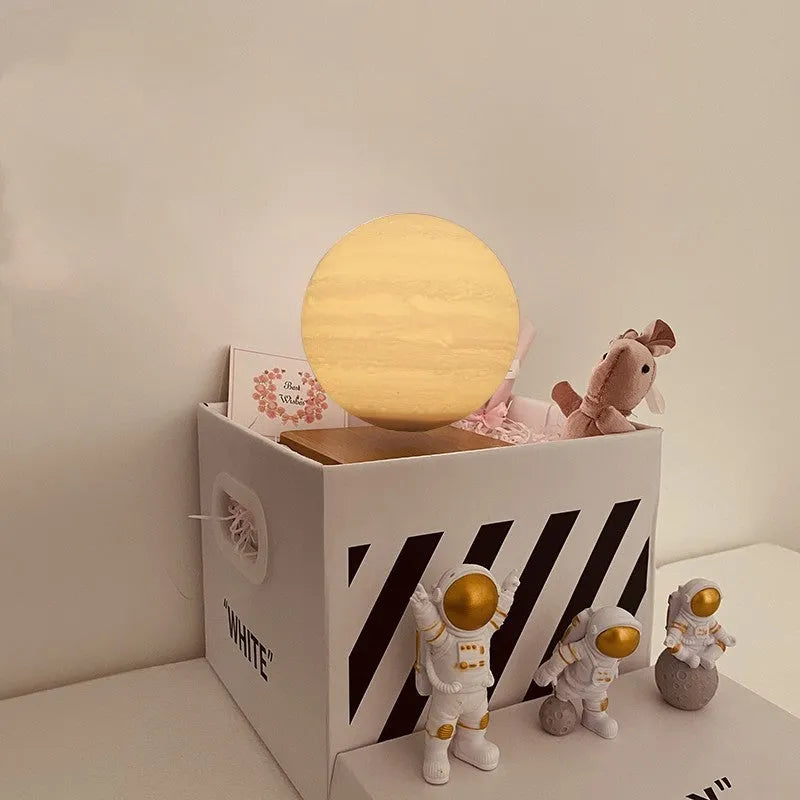 Maglev moon and planet night light floating above base with three astronaut figurines