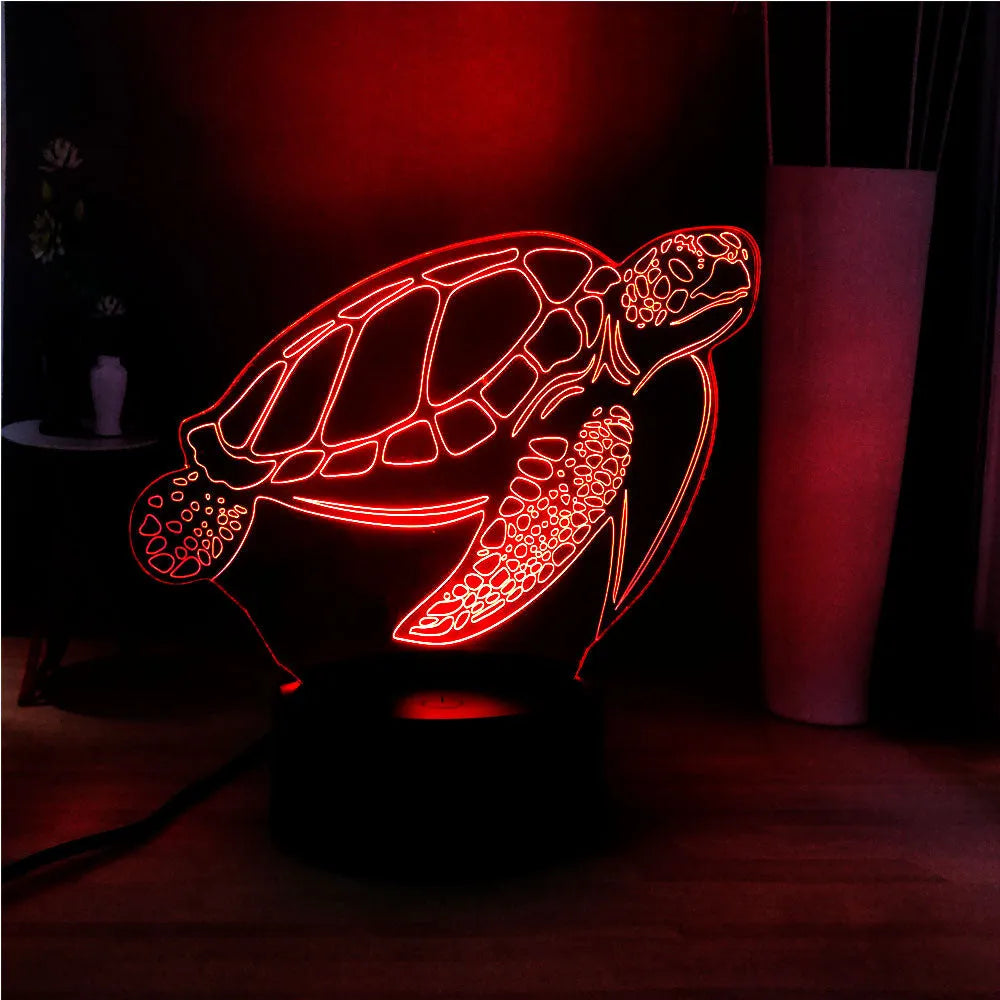 3D acrylic turtle-shaped LED night light with multi-colour glow on a surface.