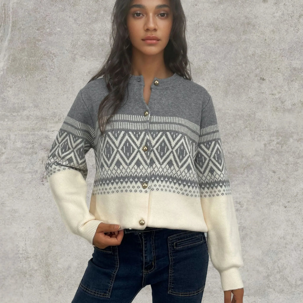 Woman wearing a red alpaca wool cardigan with a diamond knit pattern and long sleeves.