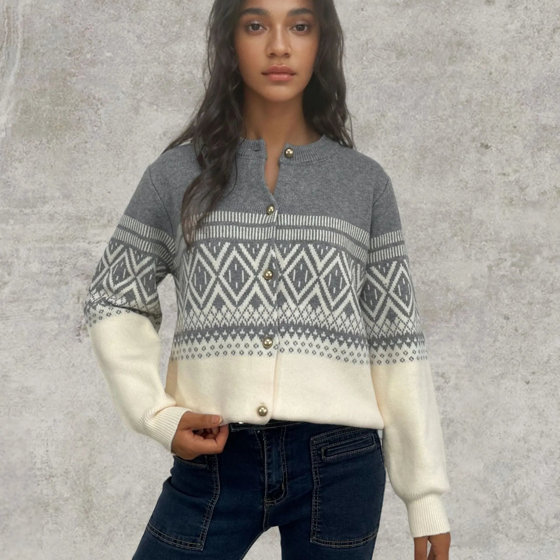 Woman wearing a red alpaca wool cardigan with a diamond knit pattern and long sleeves.