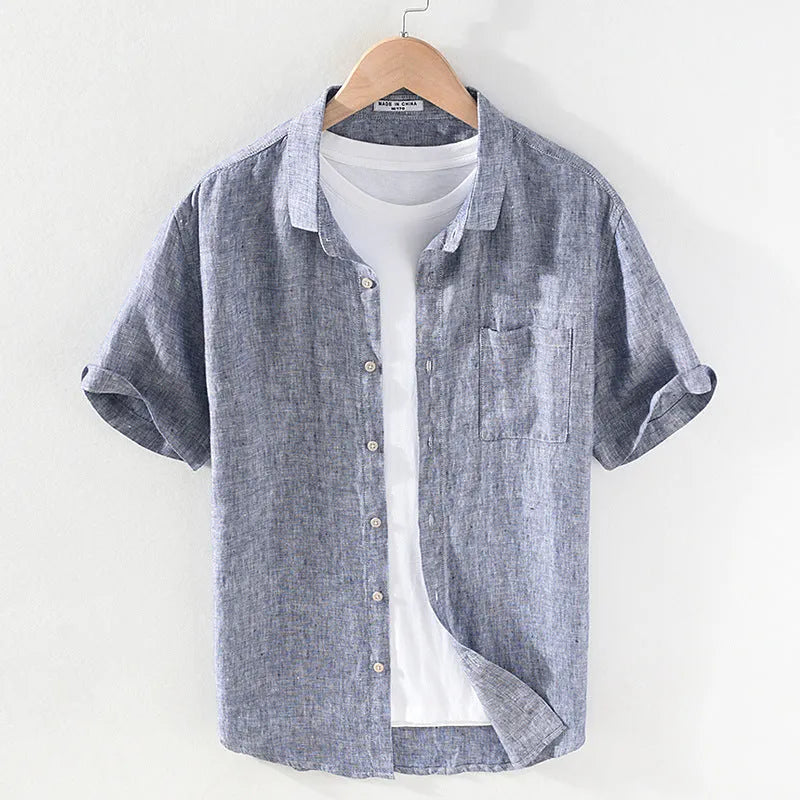 Men's raw jute coloured linen shirt with a square collar and short sleeves on a hanger.