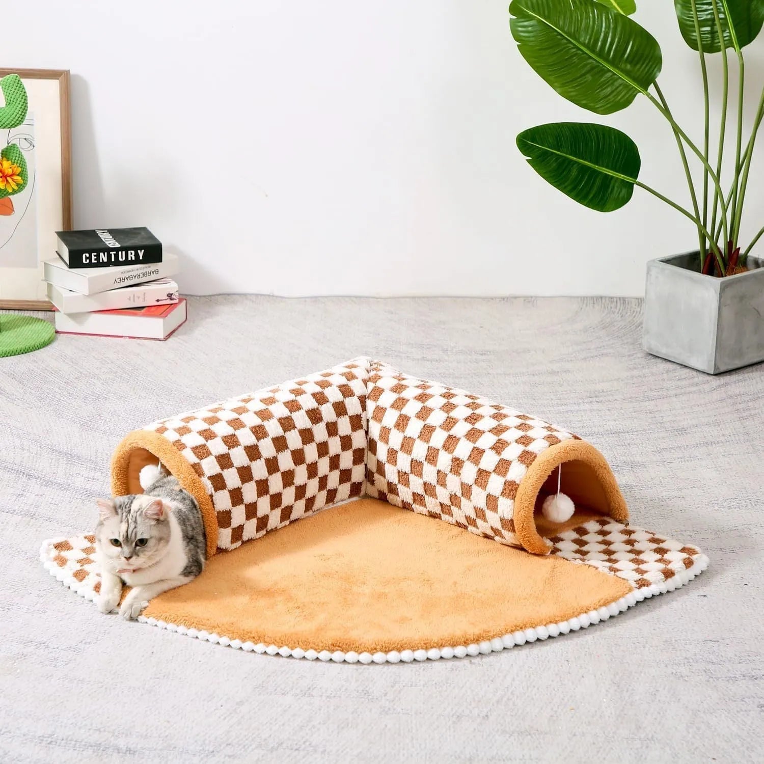 Large fan-shaped plush pet bed with attached tunnel in coffee colour on a wooden floor