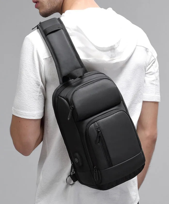 Black outdoor shoulder bag with air cushion strap showing internal laptop and organiser pockets