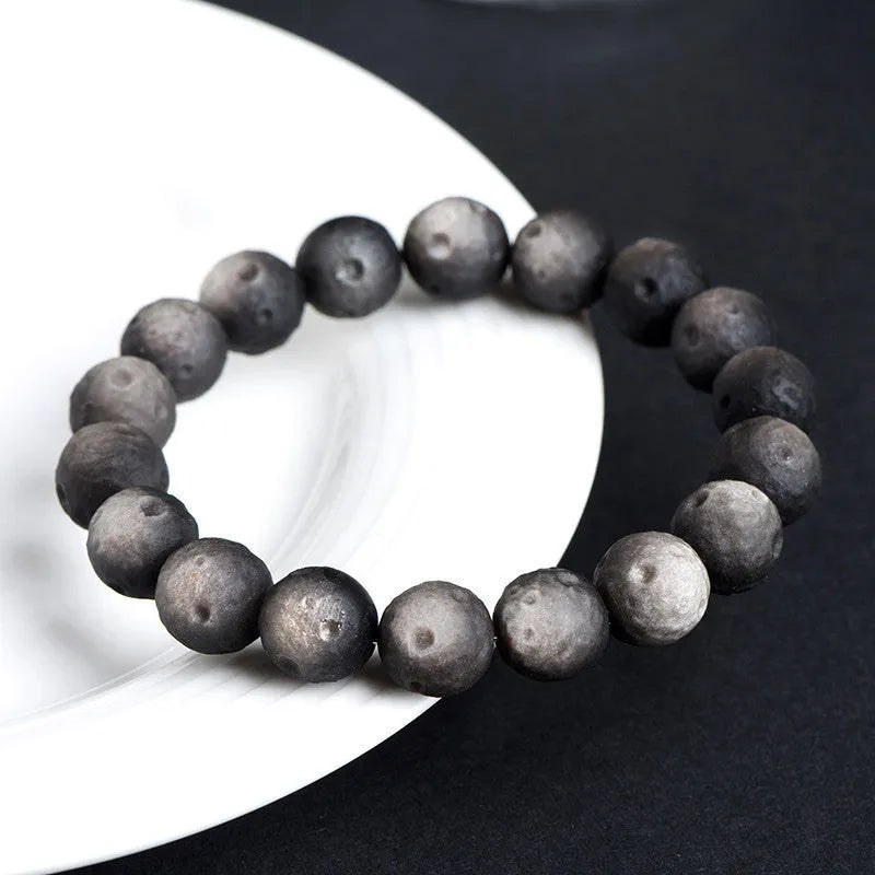 Natural obsidian crater ball bracelet with hand-ground meteorite beads in gold or silver colour options