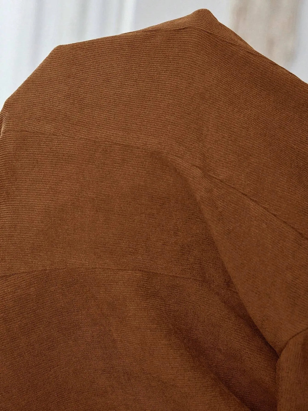 Brown men's lapel long sleeve single-breasted suit coat on a hanger