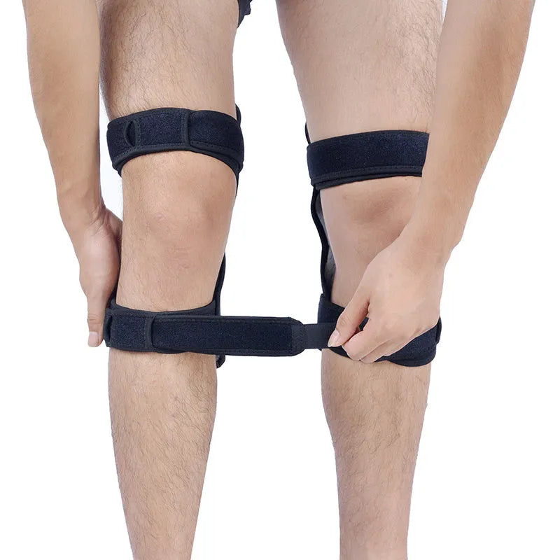 Black adjustable knee brace with patella support and visible booster spring mechanism for sports.