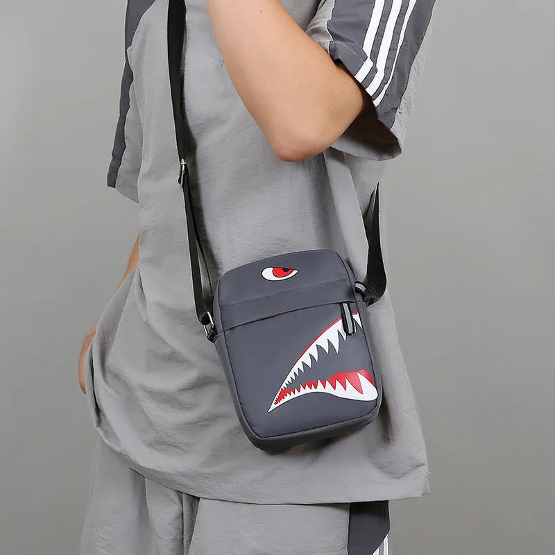 Men's black Oxford cloth crossbody bag with animal print pattern and shoulder strap.
