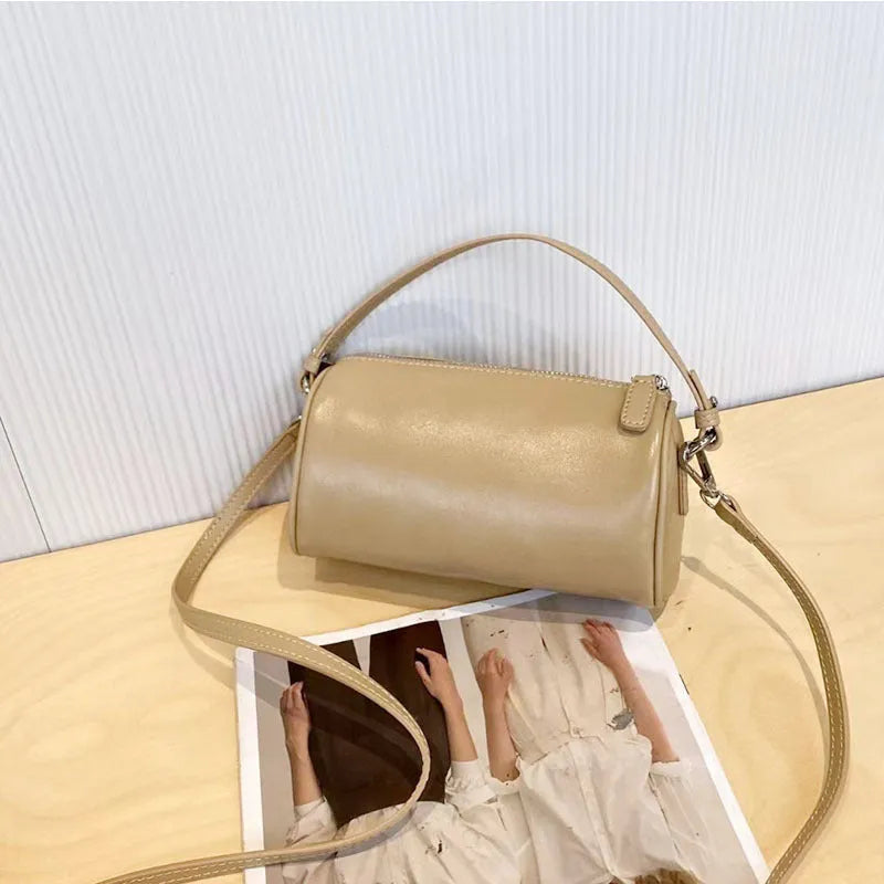 Cylindrical leather crossbody phone bag in vegetable tanned genuine leather with sewing thread detailing