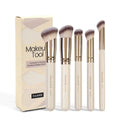 Five apricot coloured makeup brushes with angled blush brush design on white background