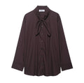 Brown women's loose fit poplin shirt with long sleeves and an integrated bow tie scarf at the neck.