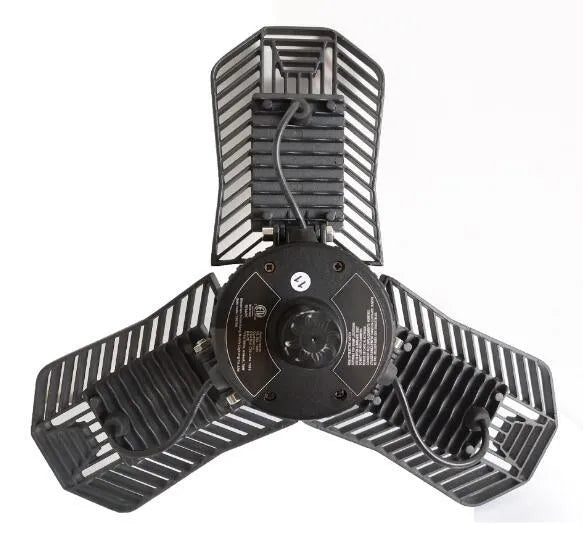 Waterproof industrial foldable garage LED lamp with die-cast aluminium housing on a workbench