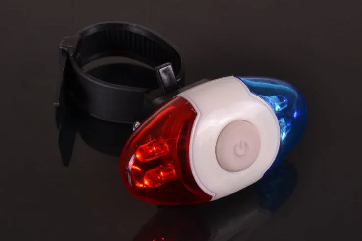 Red and blue LED tail light with adjustable mounting base on a dark background.
