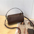 Cylindrical leather crossbody phone bag in vegetable tanned genuine leather with sewing thread detailing