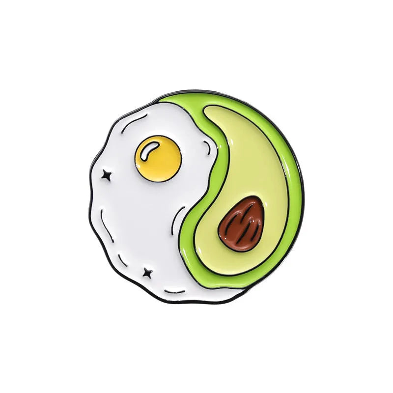 Colourful cartoon fruit design zinc alloy brooch pin on a fabric background.