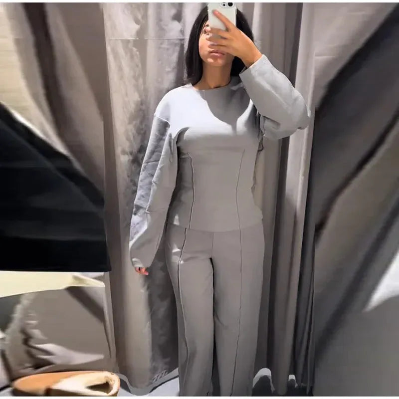 Women's black polar fleece suit set with long sleeve pleated top and wide leg trousers