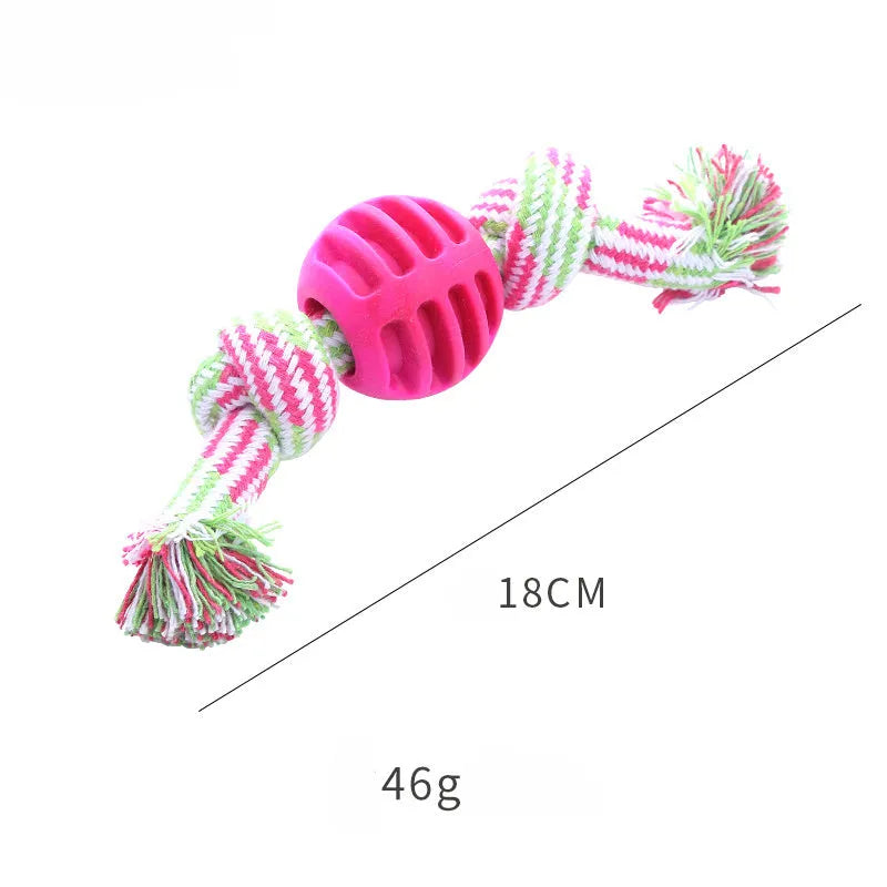 Blue silicone molar-ball dog chew toy with white rope ends on a wooden floor.