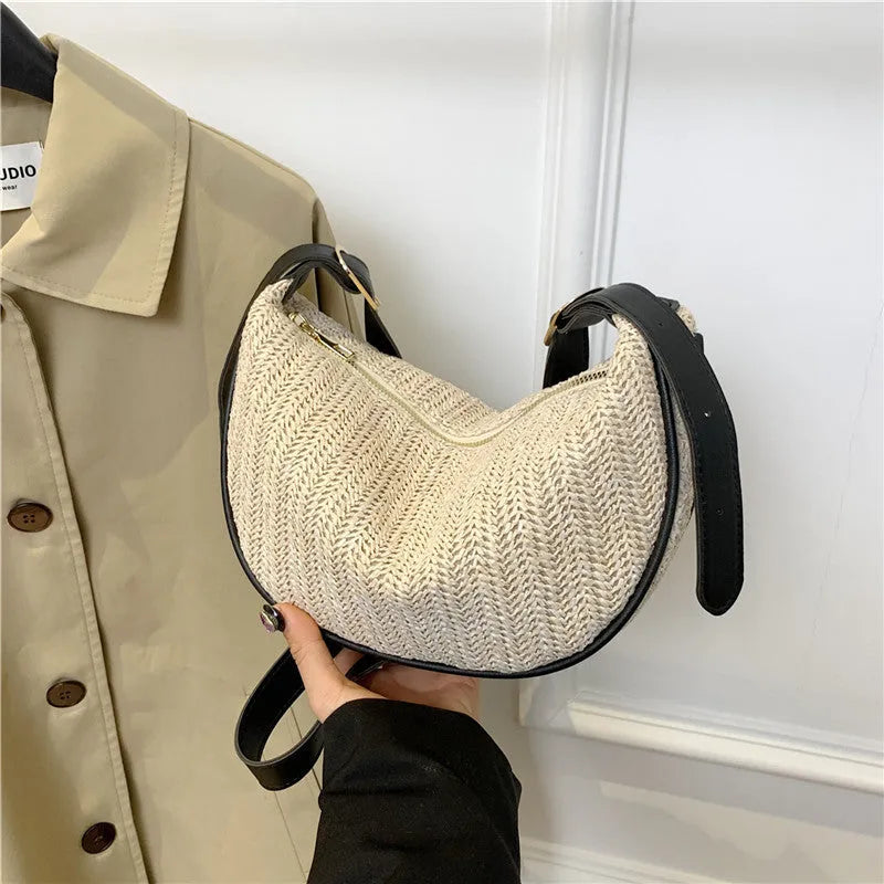 Women's straw woven crossbody bag showing woven texture and internal phone pocket
